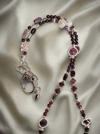 Details of Red garnet- Almandine-Pyrope necklace  showing, Rectangle, square, and round bred garnet beads in an equal design pattern on both sides , with hematite beads large silver heart shaped Lobster clasp, VERES Celtic Designs 